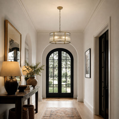 Halo 3-Light Antique Brass Ribbed Glass Pendant, in a room setting