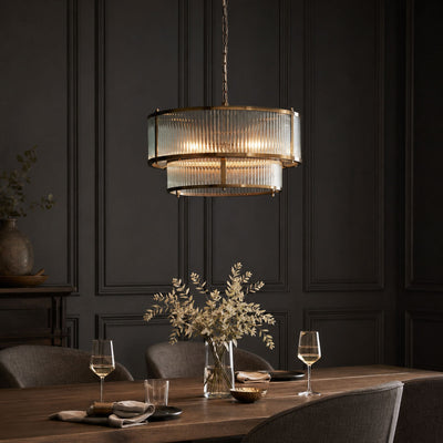 Halo 5-Light Antique Brass Ribbed Glass Pendant, in a room setting